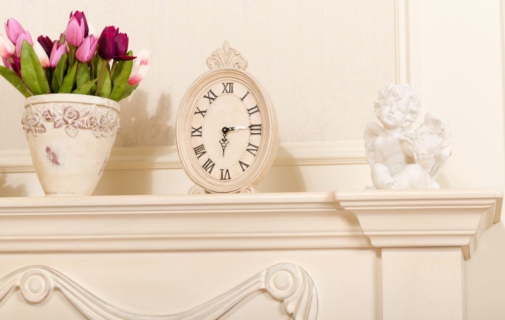 A few different décor pieces like a vase, clock, and a sculpture